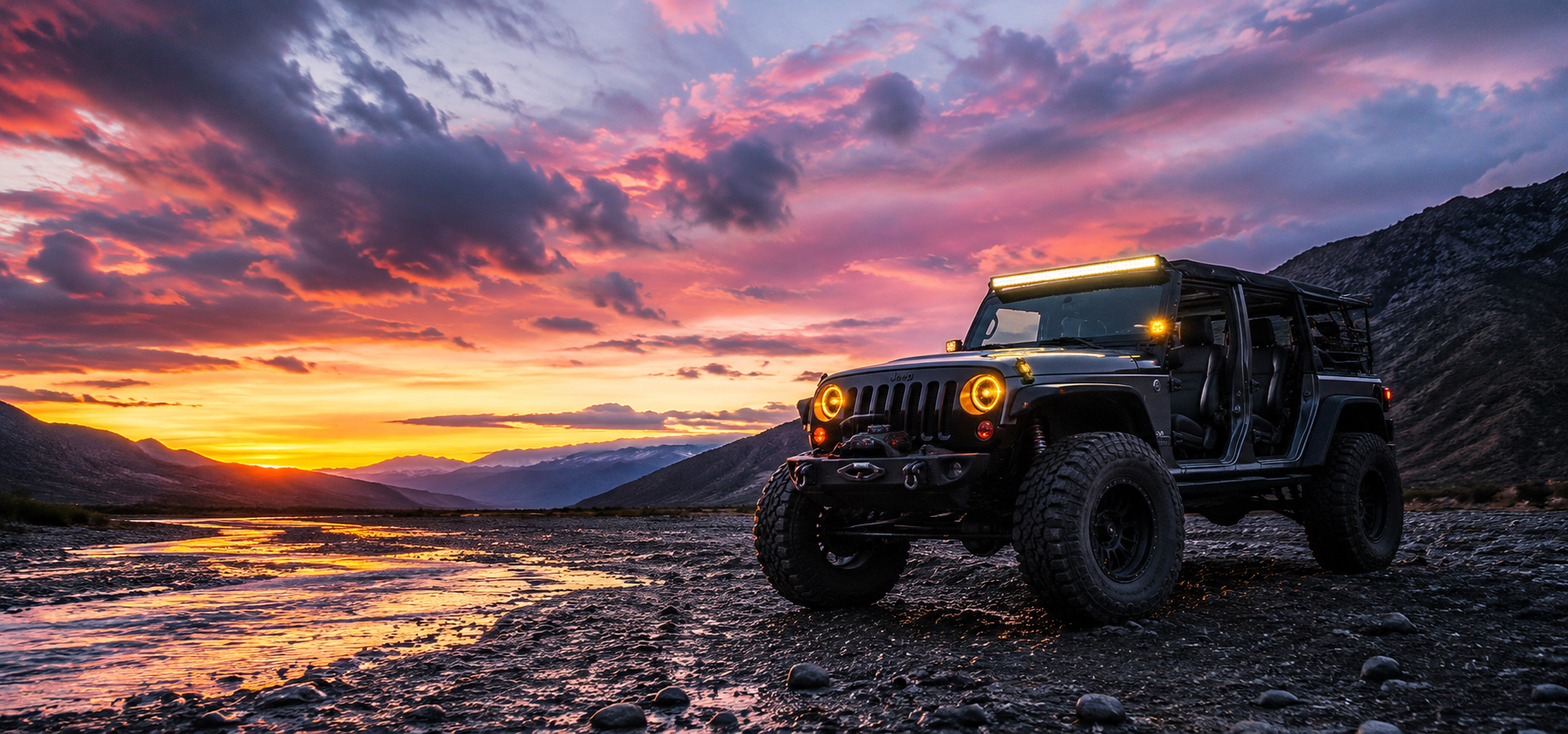 Jeep Wrangler with amber light bar lit at desert sunset